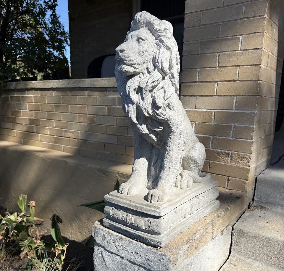 Stone lion statue on the front steps