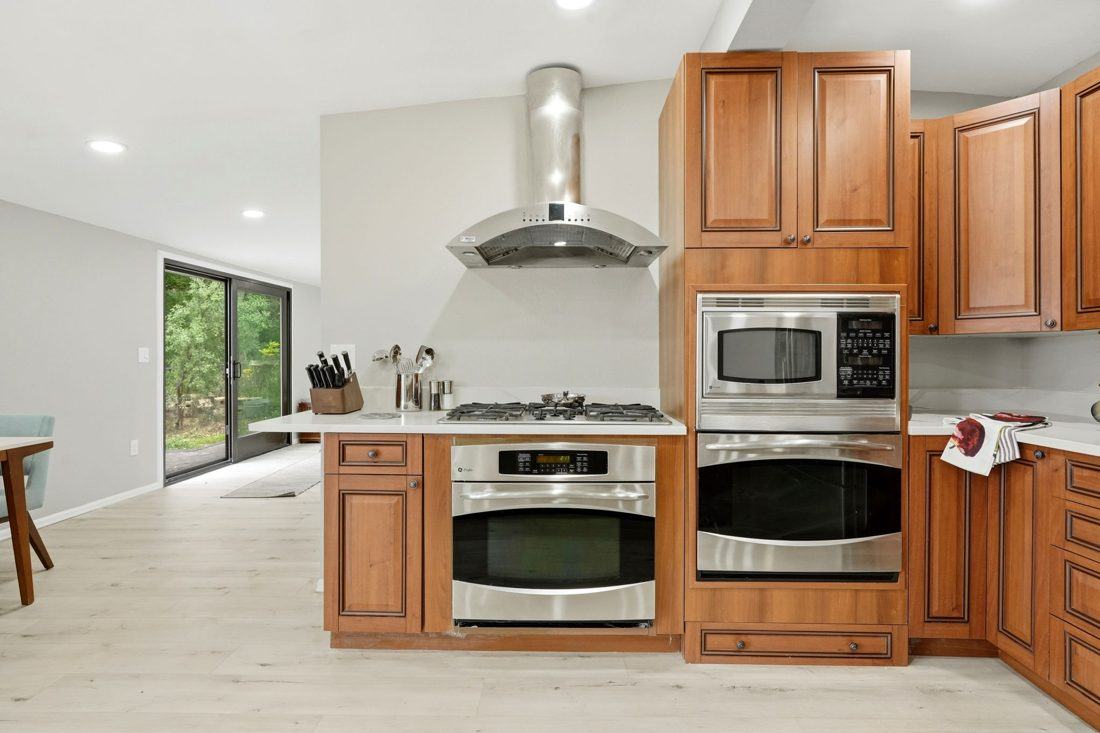 Shibumi carriage house kitchen in the carriage house with wood cabinets and stainless appliances
